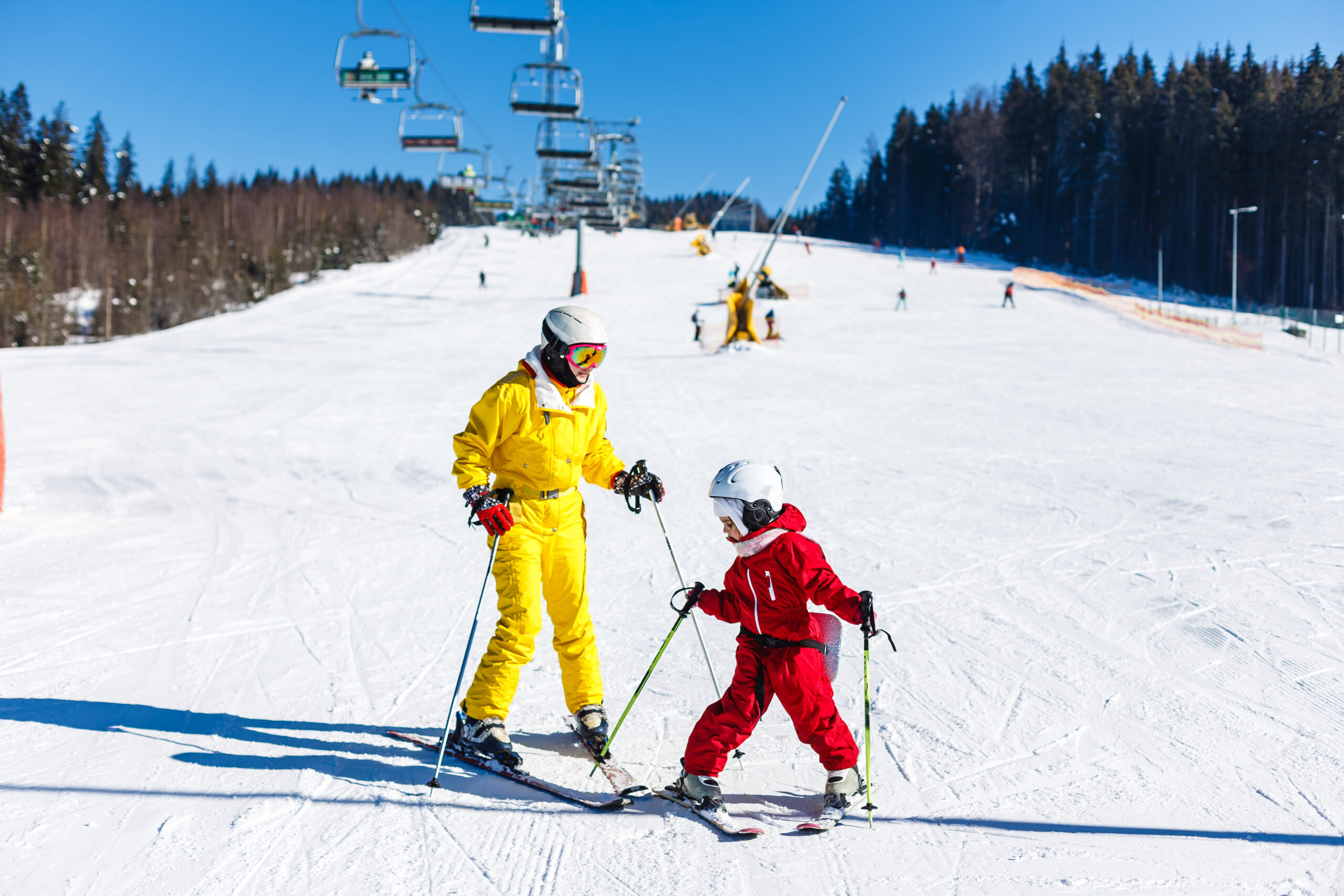 a group of people riding skis on top of a snow covered slope