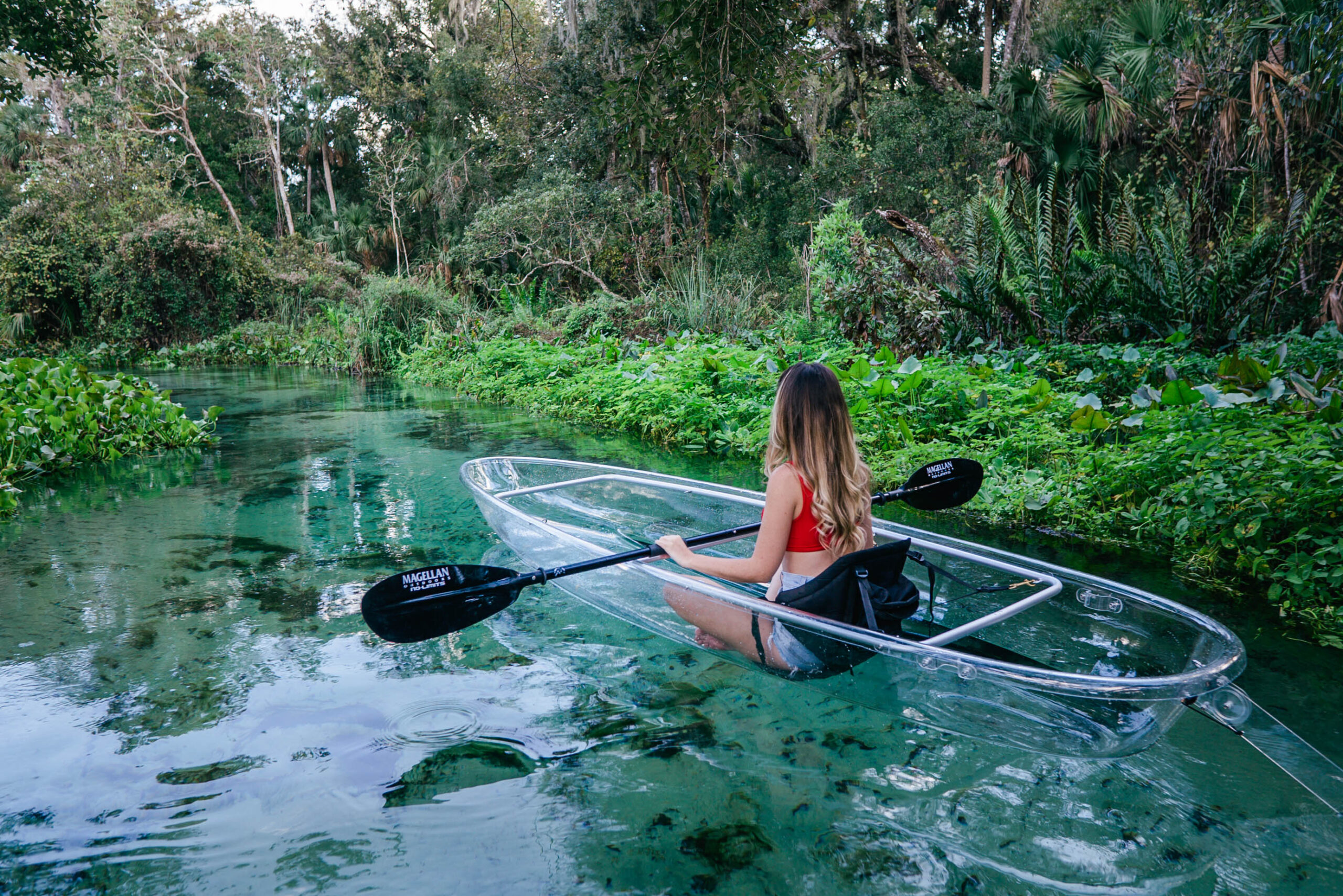 a person riding on the back of a kayak in the water