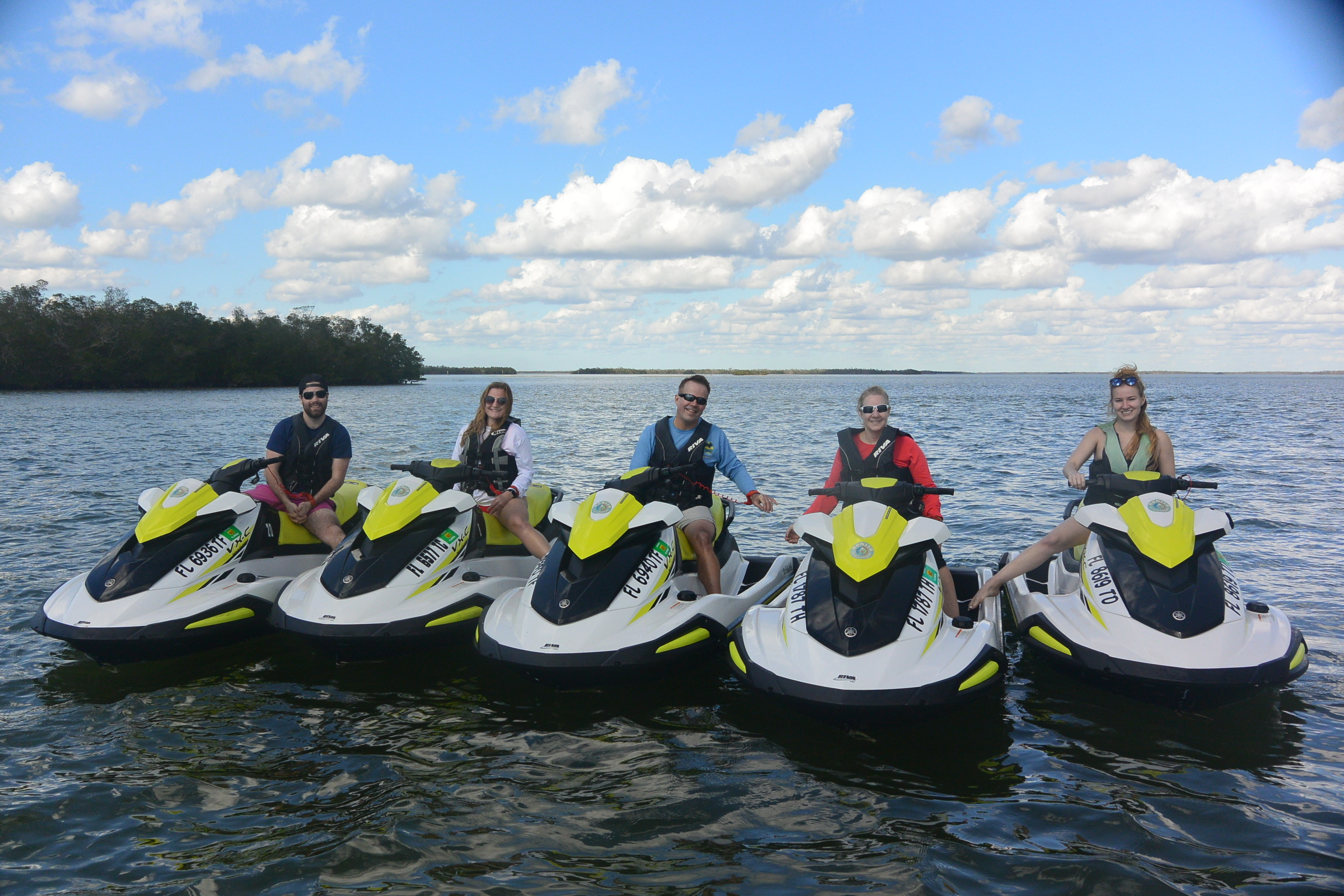 a group of people riding skis on a body of water