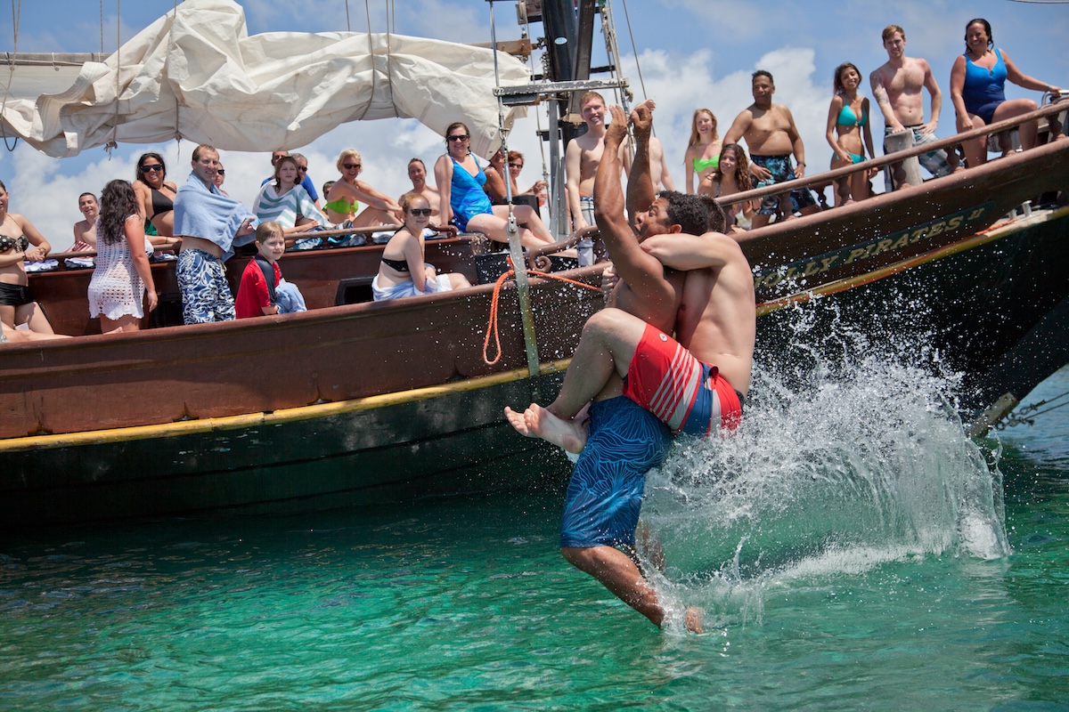 a group of people riding on the back of a boat